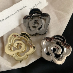 Three elegant rose flower metal hair claws in gold, silver, and black finishes