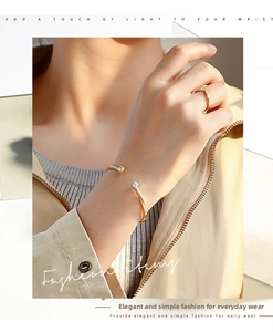 Chic 18K gold plated cuff bracelet and V-ring with zircon accents on a model's hand