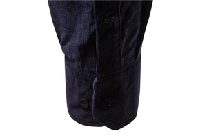 Detail view of navy blue corduroy shirt cuff featuring fine stitching and round button