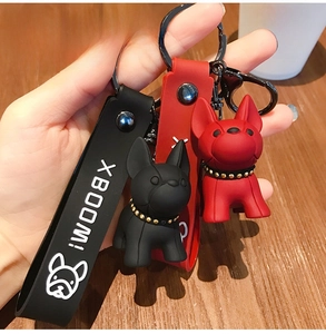 Detailed view of 3D French Bulldog keychains in black and red with XBOOM straps