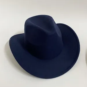 Close-up of a navy blue felt cowboy hat with stitched brim and wide brim detail