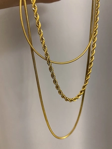 Detail of multi-layer 18K gold plated snake and twisted rope chain necklace