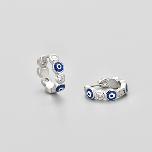 Silver hoop earrings with blue evil eye enamel and zircon stones on gray background
