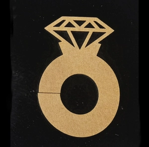 Detailed view of a gold hollow diamond ring shaped place card holder for wedding wine glasses