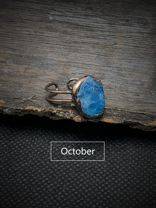 Close-up of vintage copper ring with blue raw gemstone for October birthdays