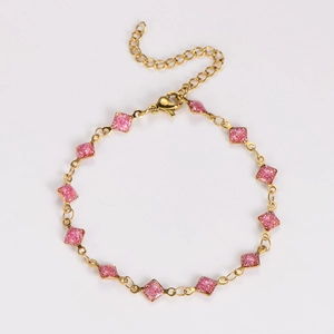Close-up of pink glitter diamond charms on a gold stainless steel adjustable chain bracelet