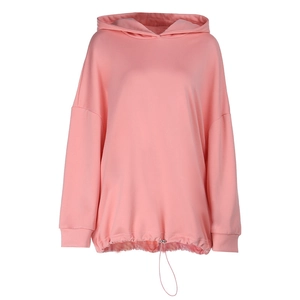 Detail of adjustable drawstring hem and ribbed cuffs on pink oversized hoodie