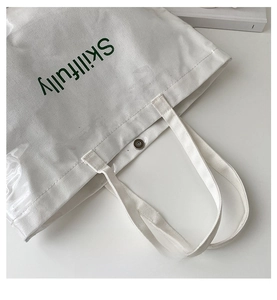 Detail of waterproof PVC outer layer and canvas interior with green Skillfully text