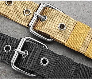 Detail of nylon canvas belts with metal pin buckles in gold and black colors