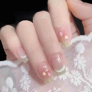 Handmade green cat eye press-on nails with tulip art and sparkling glitter details