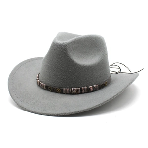 Detail of grey felt cowboy hat with steampunk gear band and bohemian beadwork