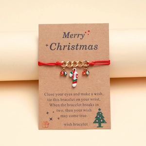 Detailed view of Christmas candy cane charm on hand-woven red rope bracelet with wish card