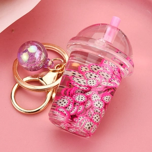 Macro detail of acrylic liquid boba keychain with pink fruit slices and glitter charm