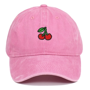 Close-up of red cherry embroidery on pink washed denim baseball cap with fine stitching