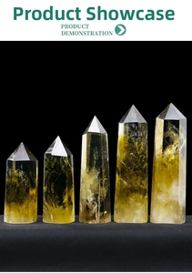 Detailed view of five citrine crystal obelisks with internal ice cracks on black background
