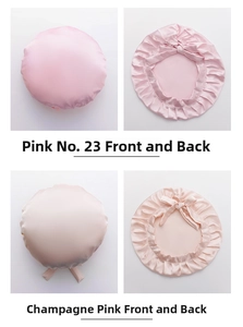 Detail view of pink adjustable satin hair caps with ruffle edges and decorative bows