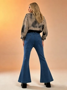 Rear view of high-waisted butt-lifting flared denim jeans paired with a crop top hoodie