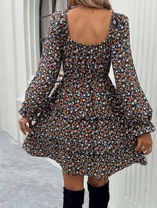 Rear view of floral square neck dress with ruffled hem and long sleeves on a model