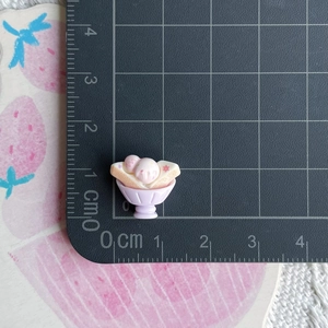Detailed macro view of a pink and white resin ice cream miniature showing 1.2cm size