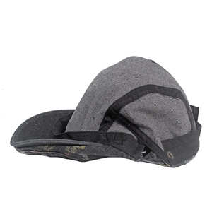 Detail view of washed denim flat cap showing side metal eyelets and contrast piping