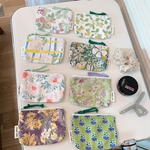 Flat lay of small floral cotton zip pouches for cards, coins and lipstick storage