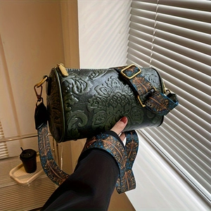 Detail of dark green embossed cylinder bag with vintage jacquard wide shoulder strap