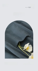 Close-up of deep teal water resistant fabric with side double pocket design detail