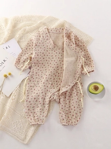 Pink floral cotton romper for baby girls with side ties and matching sun hat