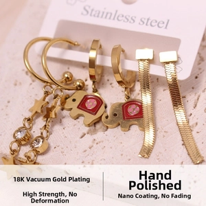 Macro shot of gold-plated stainless steel earrings set featuring lucky charm pendants
