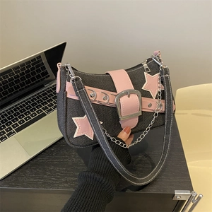 Y2K denim shoulder bag with pink star patches and metallic chain strap in hand