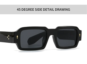 Close-up of black rectangular sunglasses with gold star rivets and thick frame detail