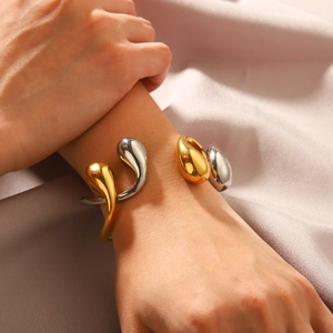 Modern 18K gold and silver two-tone open bangle with water drop metal tips on silk