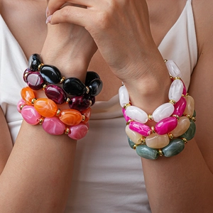 Close-up of colorful irregular oval acrylic links with marble texture on bracelets