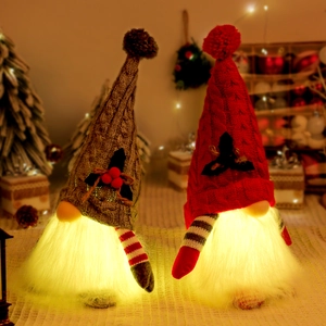 Set of two glowing Christmas gnomes with LED lights and knitted hats for festive decor