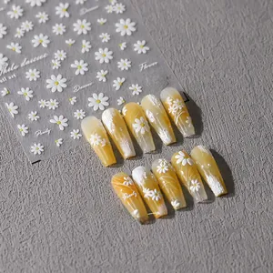 Detailed 3D white daisy nail art stickers and yellow coffin fake nails display