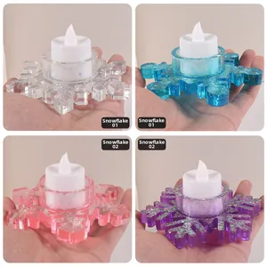 Close-up of snowflake LED candle lights in four colors with sparkling glitter resin texture