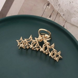 Elegant gold metal hair claw clip featuring a unique hollow star design for women hair accessory
