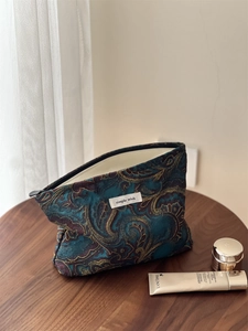 Detailed view of dark blue paisley jacquard fabric and simple wish brand label