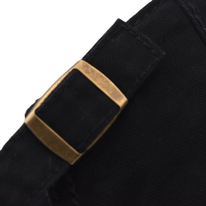Detail of adjustable metal buckle on black canvas cap with neat stitching