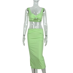 Detail view of avocado green knit crop top and slim midi skirt set with side slit