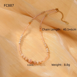 Pink freshwater pearl necklace with gold accents on soft satin background