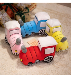 Set of four colorful plush train toys in red, pink, blue, and yellow on a soft rug