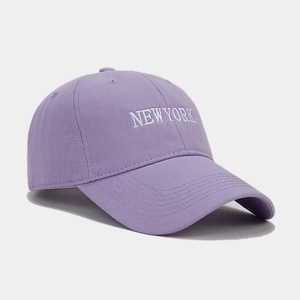 Detailed side view of purple cotton baseball cap with white NEW YORK embroidery