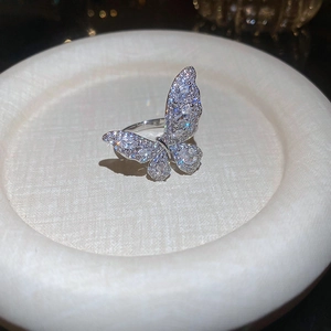 Macro detail of silver butterfly ring with shimmering white zircon stones on display