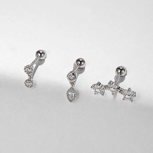 Close-up of silver s925 ear bone studs featuring zircon stars and pendant details