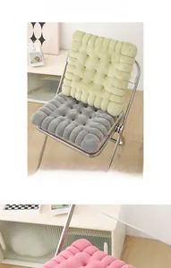 Detail of thick plush biscuit cushion with quilted surface on a clear chair