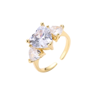Detailed macro view of an adjustable gold open ring with three heart-shaped cubic zirconia