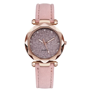 Detail of rose gold watch with diamond-cut glass, pink glitter dial and matte leather strap