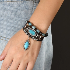 Detail of multilayer leather bracelet with turquoise pendant and beads on wrist