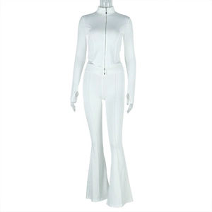 Close-up of white two-piece set featuring long-sleeve zipper top and flared trousers